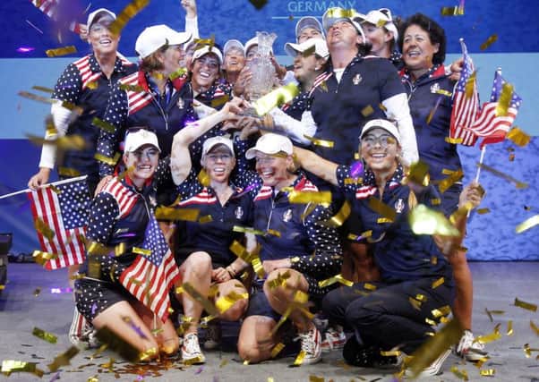 United States celebrate their Solheim Cup triumph with the trophy in St Leon-Rot, Germany (Picture: Michael Probst/AP).