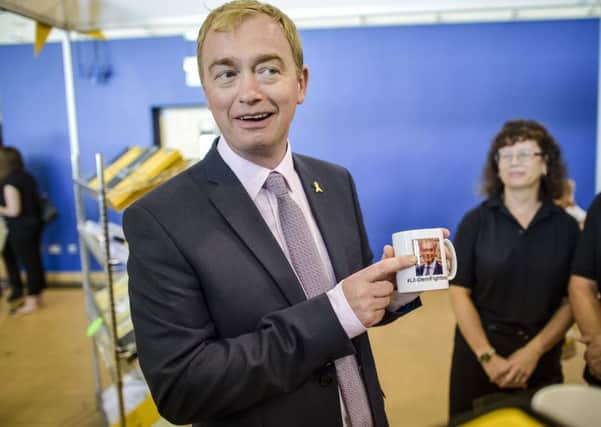Liberal Democrats leader Tim Farron holds a Liberal Democrats mug featuring a picture of himself during his walkabout at the Liberal Democrats annual conference, Bournemouth International Centre.  Ben Birchall/PA Wire