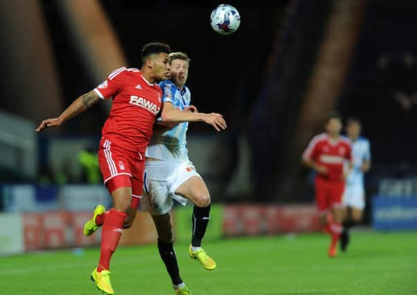 Jamaal Lascelles and John Stead challenge during last season's Capital One Cup meeting between Huddersfield and Forest. Picture: Bruce Rollinson