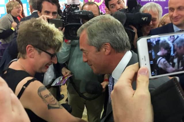 UKIP supporter Kerrie Webb hugged Nigel Farage after he autographed her tattoo of his face during the UKIP Annual Conference at Doncaster Racecourse.