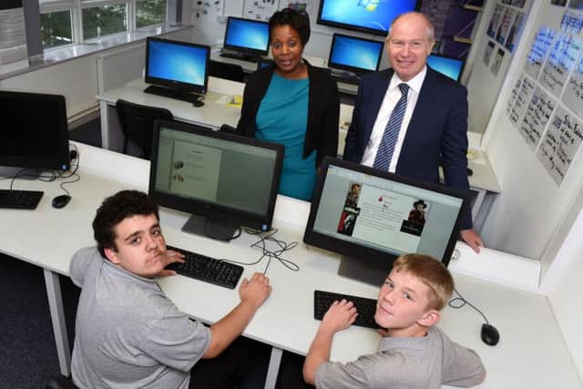 Students Kenyon Stocks (left) and Ryan Cordingley with School Partnership Trust chief executive Sir Paul Edwards and Elland Academy head Alice Ngondi.   Picture by Stephen Taylor.