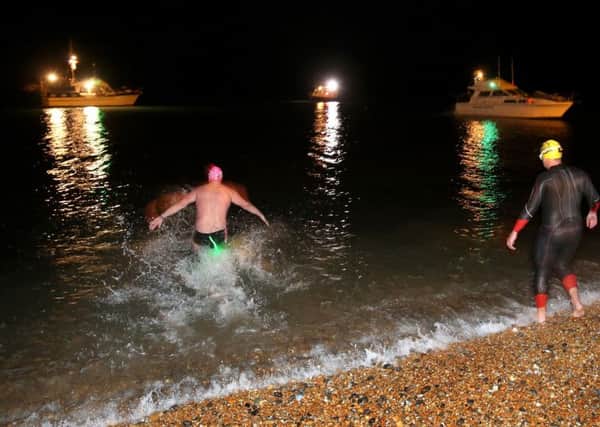 Help for Heroes Arch to Arc athletes Rob Healey, Dave Evans and Luke Reeson, enter the water at Shakespeare beach near Dover at the start of the cross channel swim during the Enduroman Arch to Arc challenge. PRESS ASSOCIATION Photo. Picture date: Saturday September 26 2015. Athletes taking part will be the first disabled team to do the 300 mile triathlon. The event started with an 87 mile run from London's Marble Arch to the Dover coast, participants must then swim across the English Channel to the French coast, and finally finish with a 181 mile bike from Calais to the Arc de Triomphe in Paris. See PA Story DEFENCE Arc. Photo credit should read Chris Radburn/PA