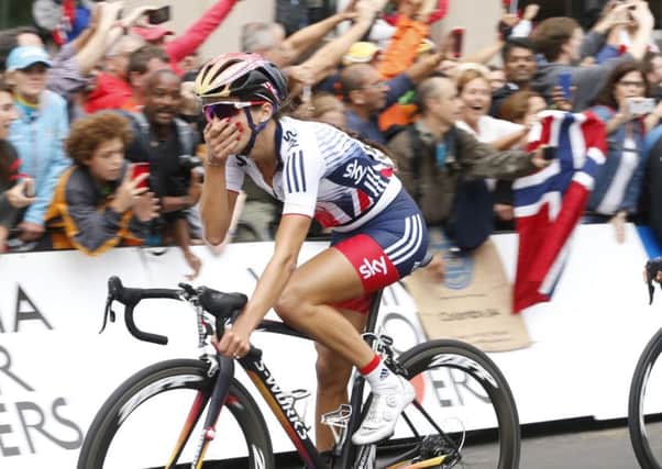Lizzie Armitstead, of Britain, puts her hand to her mouth as she crosses the finish line to win the UCI Women's Road World Championship Cycling race in Richmond. (AP Photo/Steve Helber)