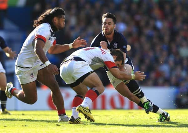 Scotland's Sean Maitland (right) is tackled by USA's Thretton Palamo (left) and Seamus Kelly at Elland Road. Picture: Nigel French/PA.