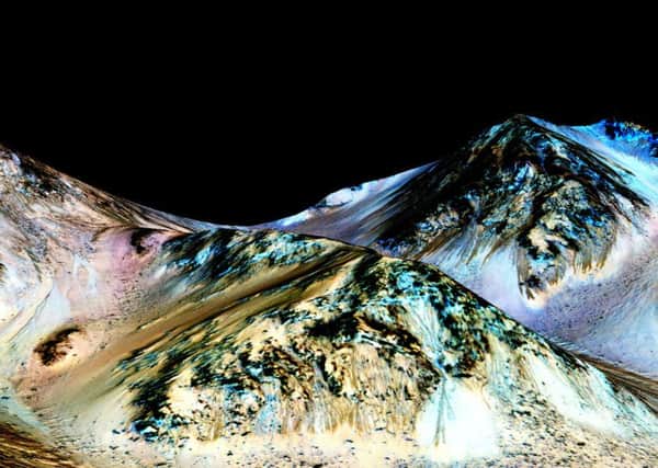Scientists believe that flowing liquid water is almost certainly responsible for mysterious features on Mars that change with the seasons.