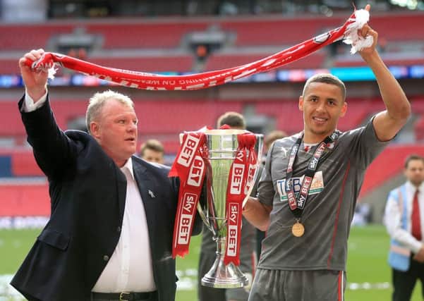 Rotherham United manager Steve Evans celebrates with James Tavernier and the Sky Bet League One Play Off trophy after the Sky Bet League One Play Off Final at Wembley Stadium, London. (Picture: Mike Egerton/PA Wire).