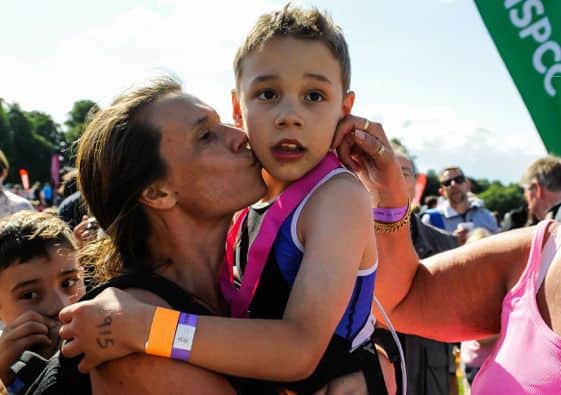 Bailey Matthews  Doncaster  gets a kiss from his mother  Julia  after he crossed the finish line  to complete his first ever triathlon at Castle Howard