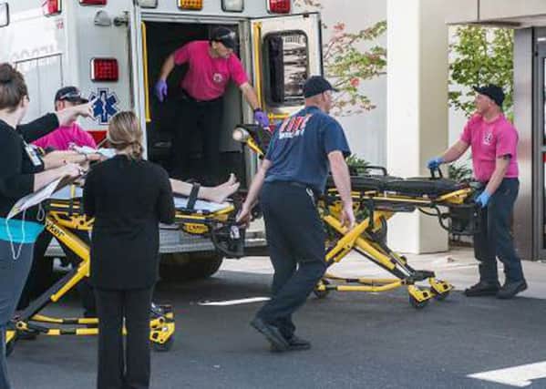 A patient is wheeled into the emergency room at Mercy Medical Center in Roseburg, Ore., following a deadly shooting at Umpqua Community College, in Roseburg, Thursday, Oct. 1, 2015.  (Aaron Yost/Roseburg News-Review via AP)