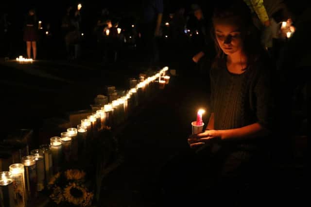Kindra Neely, of Roseburg, Oregon, attends a candlelight vigil at Umpqua Community College. (Michael Sullivan/The News-Review via AP)