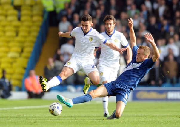 Leeds United's Lewis Cook is tackled by City's Maikel Kietenbeld.