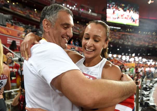 Sheffield's Jessica Ennis-Hill celebrates with her coach Toni Minichiello after winning gold in the heptathlon at the IAAF World Championships at the Beijing. Picture: PA.