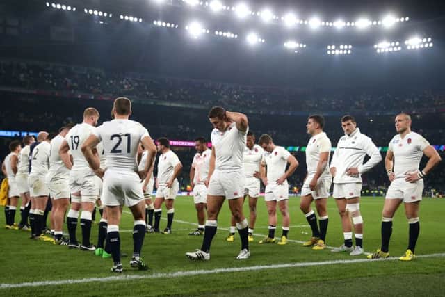 England's players stand dejected after losing to Australia at Twickenham on Saturday night.