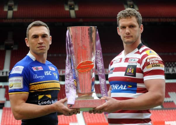 Leeds Rhinos Kevin Sinfield, left, with Wigan's Sean O'Loughlin and the Super League Trophy
