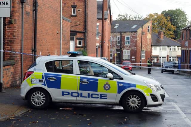 Police at the scene in Moorfield Avenue and Back Moorfield Terrace, Armley, Leeds. PIC: James Hardisty