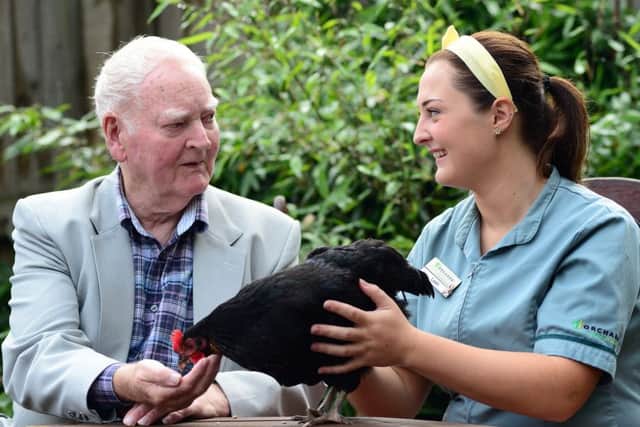 Resident Eamon McMahon with care assistant Leah O'Leary. Picture Scott Merrylees