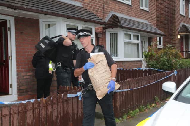 Police officers leaving Eastcroft Road, Wallasey after searching the premises, as two men have been arrested over the murder of Pc David Phillips, who was mown down and killed by a driver in a stolen car.