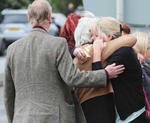 The family of Pc David Phillips, wife Jen and daughters Abigail and Sophie visit the scene in Wallasey where the Merseyside officer was mown down and killed by a stolen car early on Monday.
