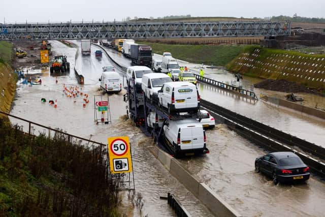 Traffic crawls through flood water both ways on the A1 between the two A6136 Catterick junctions following heavy rain overnight. Highways are working to pump the water away and alleviate the traffic. Picture: Ross Parry Agency