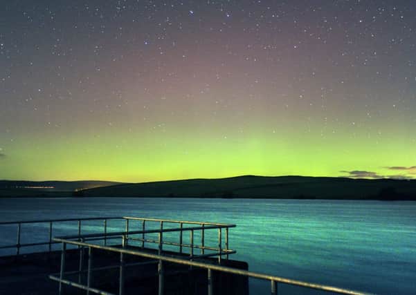 The Aurora Borealis seen last night over Chelker Reservoir, Addingham.   Picture Bruce Rollinson