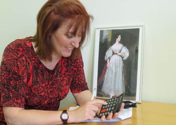 Leader of Ashfield District Council, Councillor Cheryl Butler, ponders over some fiendish maths puzzles using a calculator. Ada Lovelace's work inspired the invention of the calculator.