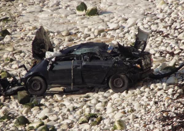 The remains of the car at the foot of the cliff