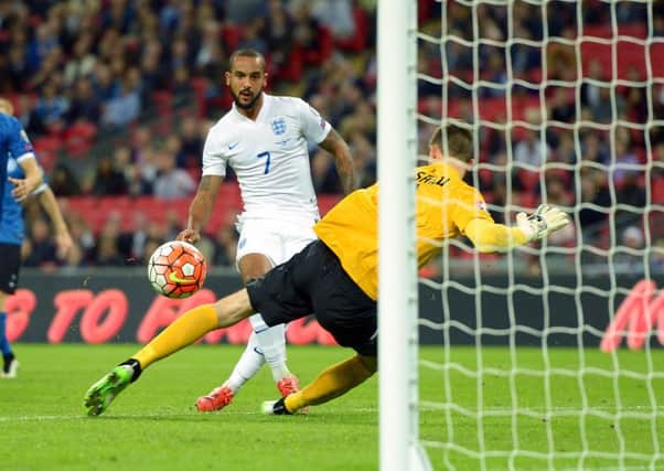 England's Theo Walcott scores his side's first goal.