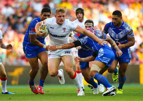 Tom Burgess surges through the Samoan rearguard during Englands game in the Four Nations in Australia last year (Picture: Patrick Hamilton/SWPIX).