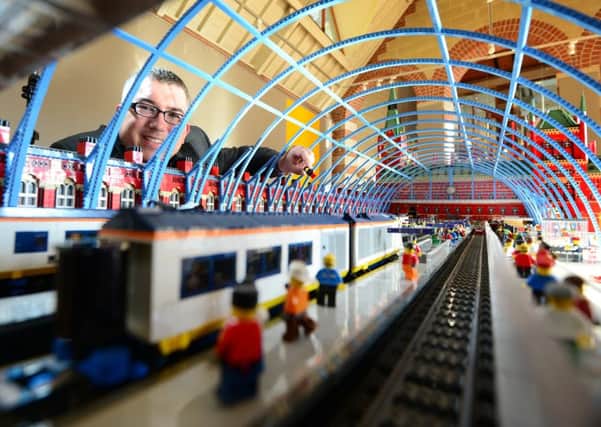 Lego Masterbuilder Warren Elsmore puts the finishing touches to his models. Picture Scott Merrylees