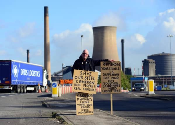 Neil Dawson stages a one man protest outside the Tata Steelworks in Scunthorpe as it was announced that 900 jobs were to be axed. Picture: Scott Merrylees