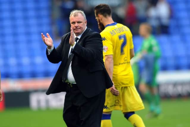 United's head coach Steve Evans claps the travelling fans at Bolton.