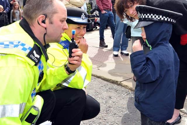 Jonny Minshull, 3, from Beeston, gets to try on a police cap at Morley's annual St George's Day parade in 2013