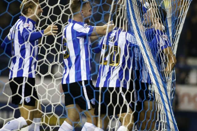 Sam Hutchinson, right, is congratulated after scoring Sheffield Wednesdays final goal in their 3-0 League Cup victory over Arsenal at Hillsborough last night. Picture: Steve Ellis