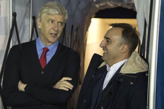 Arsene Wenger and Carlos Carvalhal share a joke in the tunnel before the game