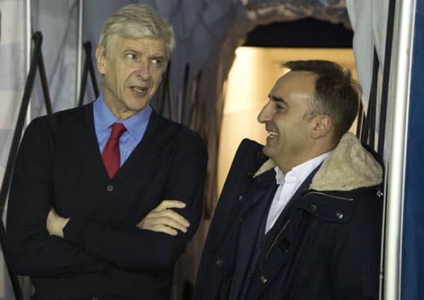 Arsene Wenger and Carlos Carvalhal share a joke in the tunnel before the game