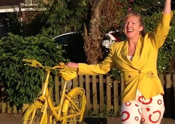 Ruth Whiteley with yellow bike, at the time of the Tour de France in Yorkshire last year