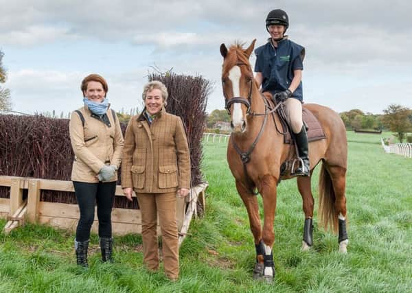 Katie Sharman, West of Yore Hunt committee member, Liz Philip, and student Amy Clarke riding five-year-old Falco.