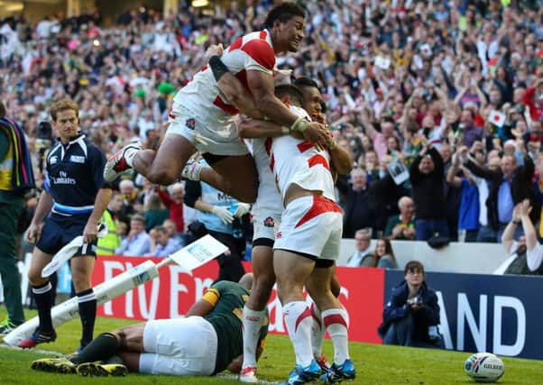 Japan's Karne Hesketh (right) celebrates with team mates after scoring the winning try during the Rugby World Cup match at the Brighton Community Stadium, Brighton.