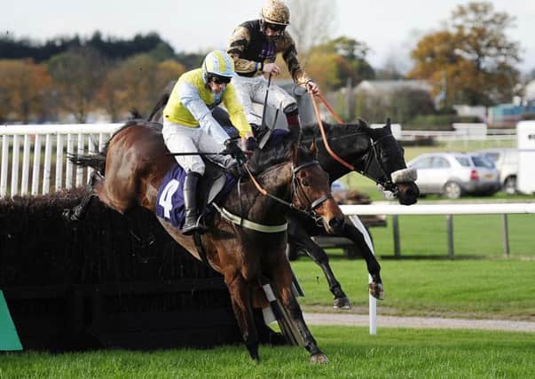 Jockey Sam Twiston-Davies (right), who finished second, is shot from the saddle on Fago as he challenges eventual winner Wakanda and Danny Cook at the final fence in the bet 365 Handicap Chase during the bet365 Charlie Hall Meeting at Wetherby Racecourse.