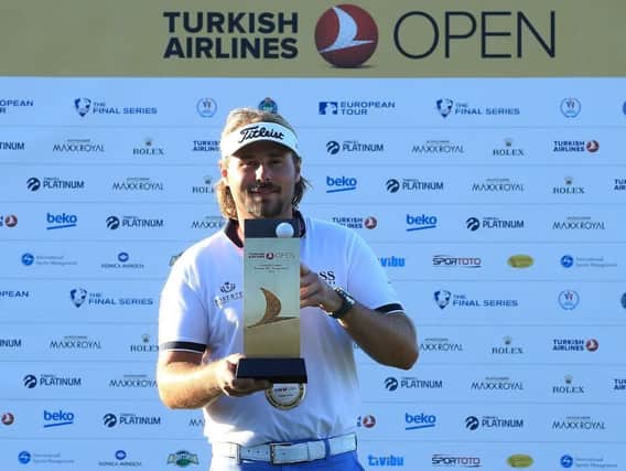 Turkish Airlines Open winner Victor Dubuisson with the trophy (Picture: Getty Images).