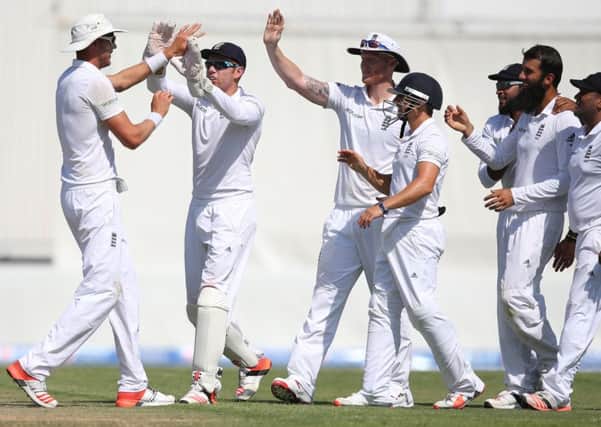 Englands players celebrate the dismissal of Pakistans batsman Muhammed Hafeez on day one of the third Test (Picture: Kamran Jebreili/AP).
