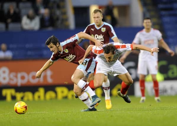 Burnley's Joey Barton holds Huddersfield Town's Dean Whitehead off the ball.  Picture: Bruce Rollinson