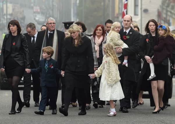 Jen Phillips (centre) and daughters Sophie, 3, (being carried at rear) and Abigail, 7, (front right) follow the coffin of Pc Dave Phillips as it makes its way to Liverpool's Anglican Cathedral