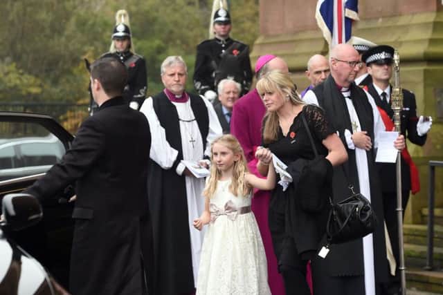 Jen Phillips and daughter Abigail, 7, outside Liverpool's Anglican Cathedral after the funeral service for Pc Dave Phillips