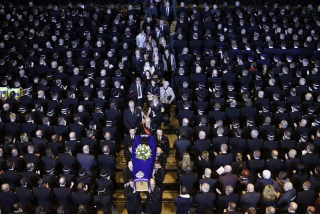 The coffin of Pc Dave Phillips is carried out of Liverpool's Anglican Cathedral