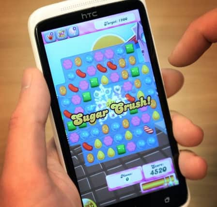 File photo dated 08/12/14 of a man playing Candy Crush Saga on his mobile telephone, as gaming giant Activision Blizzard is set to buy the maker of Candy Crush in a deal worth 5.9 billion US dollars (£3.82 billion). PRESS ASSOCIATION Photo. Issue date: Tuesday November 3, 2015. Activision said the purchase of King Digital Entertainment would "create one of the world's largest entertainment networks" with more than half a billion active users in 196 countries. See PA story CITY CandyCrush. Photo credit should read: Stefan Rousseau/PA Wire