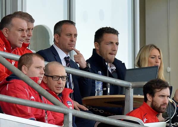 Sam Burgess, right, sitting next to England coach Steve McNamara during the Test against France