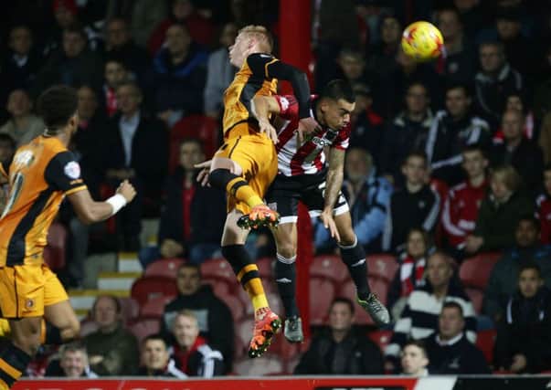 TOP DOGS: Hull City's Sam Clucas, left, and Brentford's Nico Yennaris challenge for the ball at Griffin Park on Tuesday night. Picture: Yui Mok/PA.