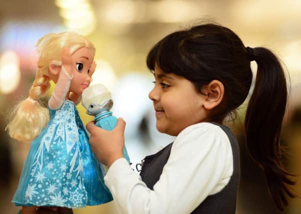 Sannah Khalid from Tinsley Meadow School in Sheffield tests out a 'Frozen Simg-A-Long Elsa', one the top toys for Christmas 2015. Picture Scott Merrylees