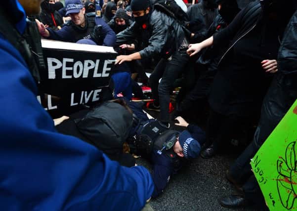 A police officer on the ground during protests in London.