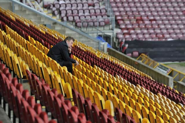 A lone man stand at Valley Parade on the day of the 30th anniversary of the Bradford City fire memorial service, Centenary Square, Bradford.  11 May 2015.  Picture Bruce Rollinson